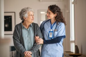 nurse walking with patient smiling